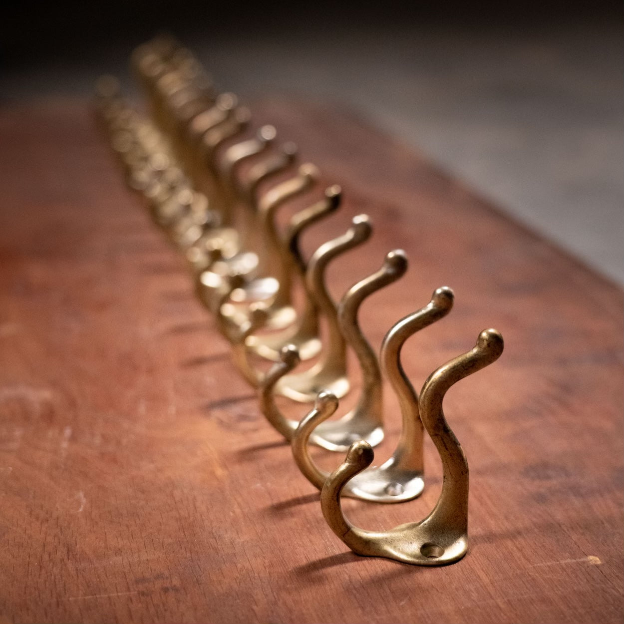 1930 group of 12 brass coat hooks