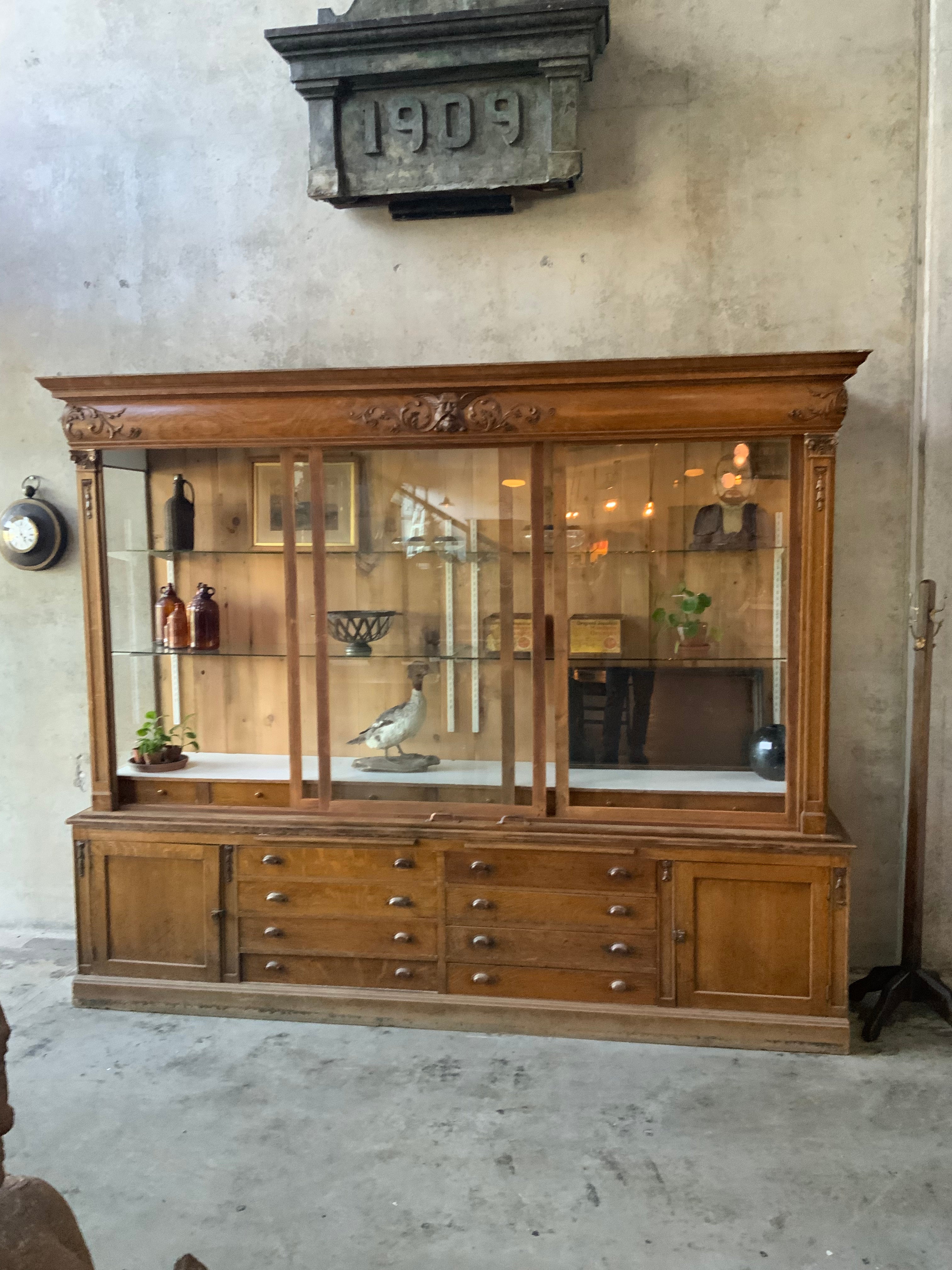 C1900 mercantile apothecary showcase oak display cabinet | Scott Landon Antiques and Interiors.