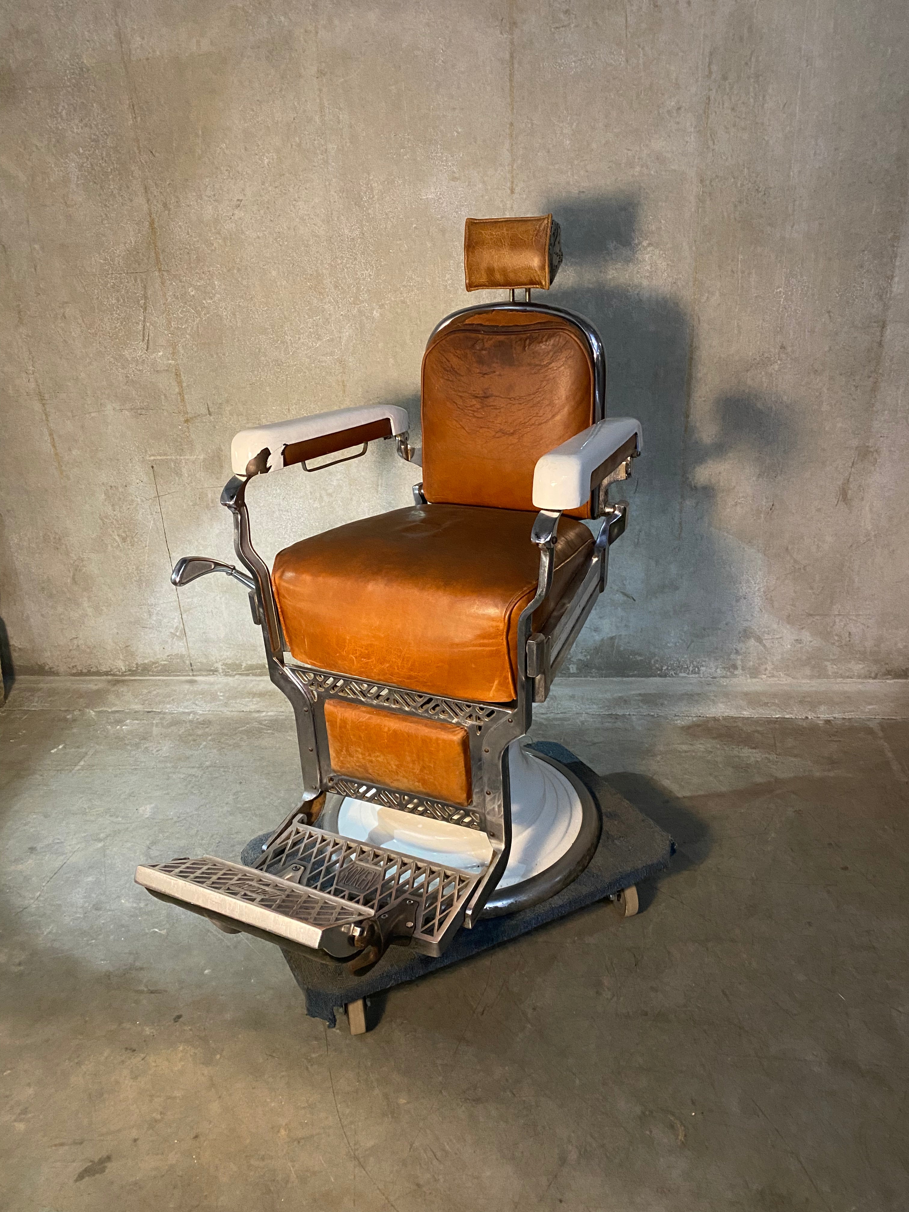 Koken first generation Porcelain barber chair  in old Leather | Scott Landon Antiques and Interiors.