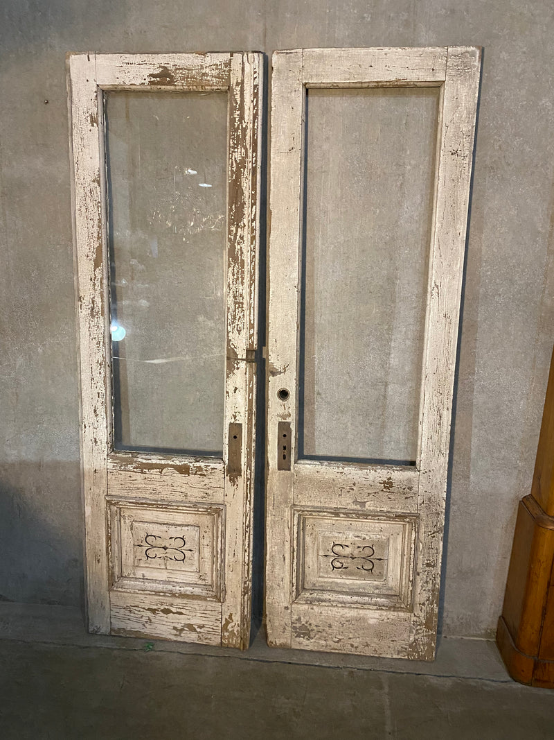 1880 pair of entry doors from in old paint  from a grey stone in CHICAGO | Scott Landon Antiques and Interiors.