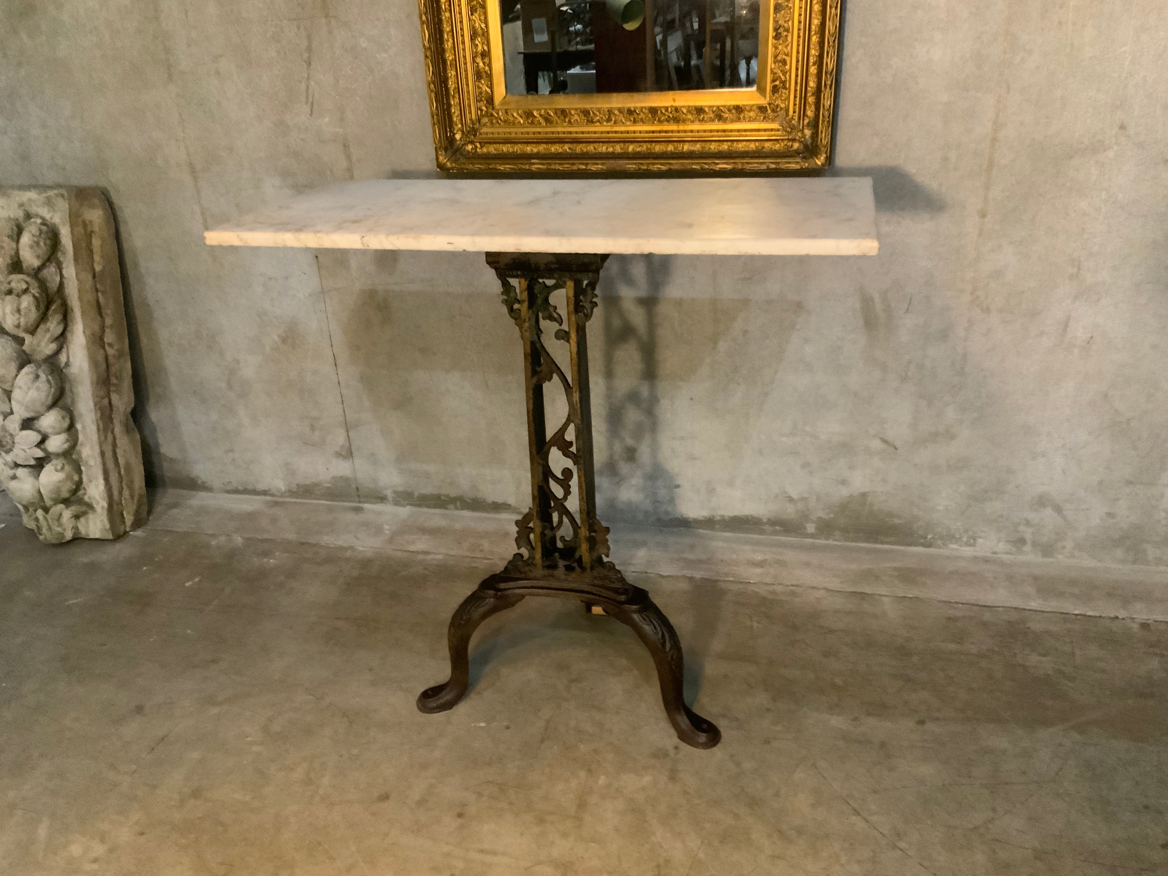 C 1900  cast iron detailed table base with marble top | Scott Landon Antiques and Interiors.