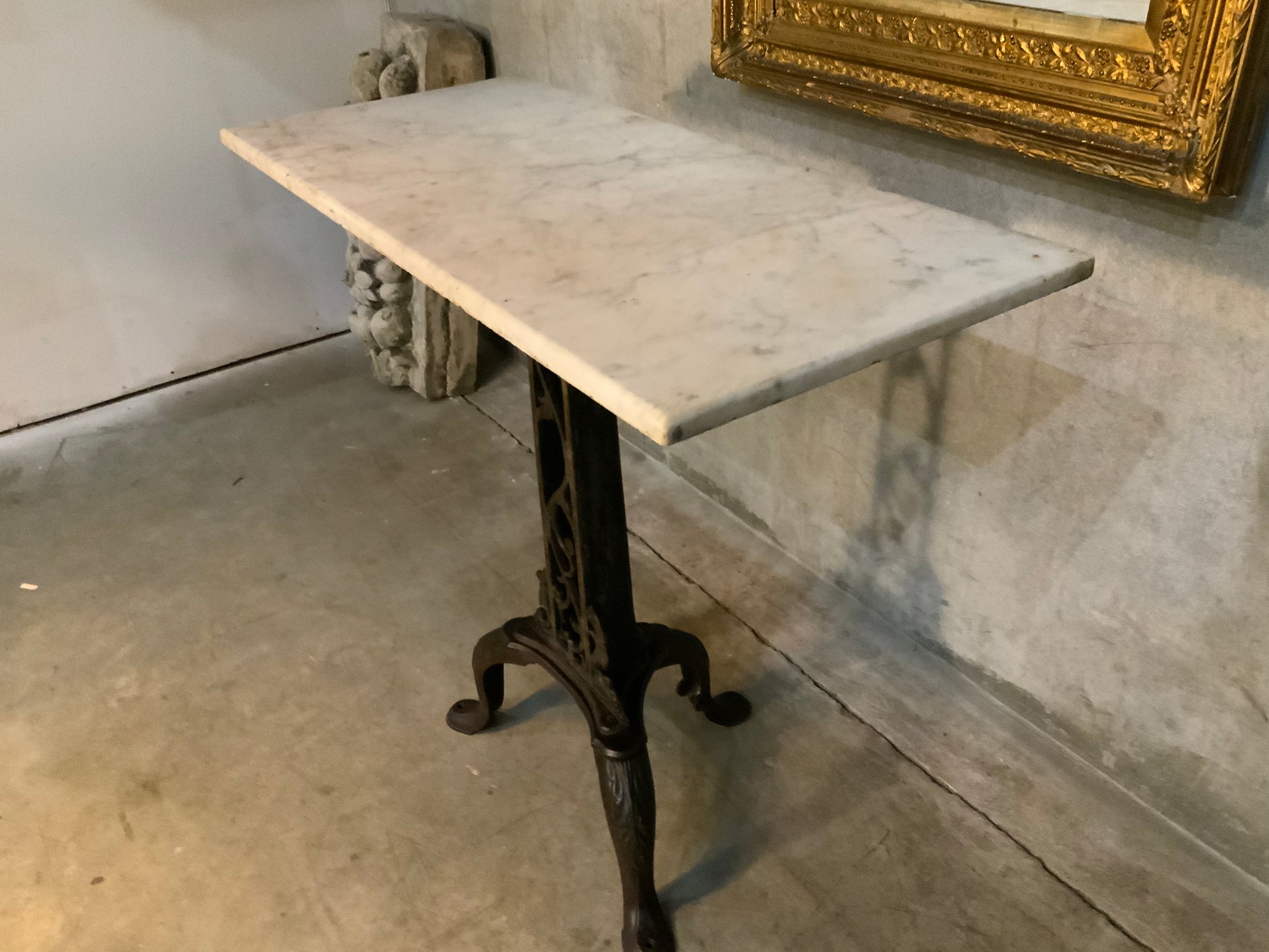 C 1900  cast iron detailed table base with marble top | Scott Landon Antiques and Interiors.