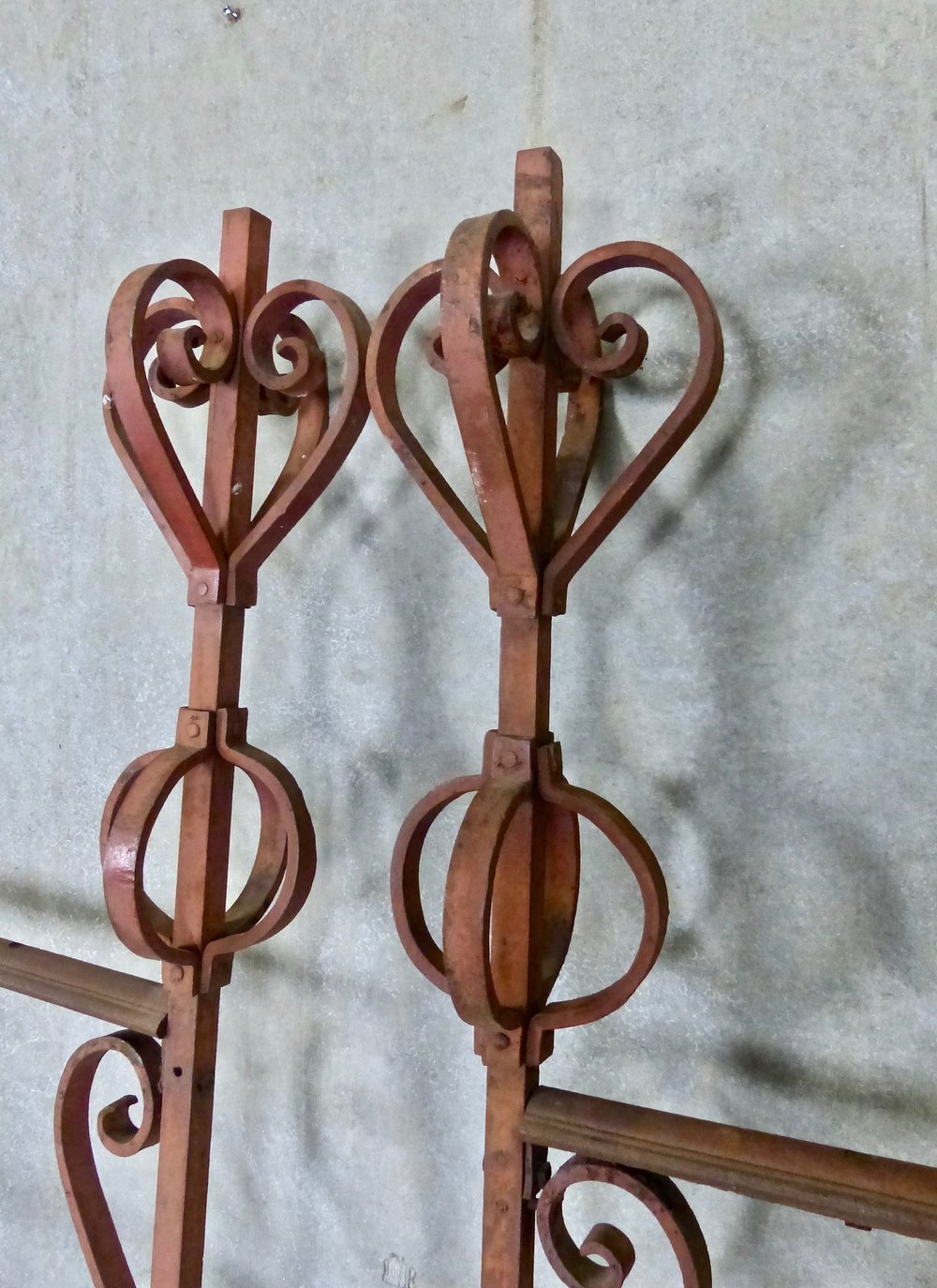 C 1900 Antique wrought iron French driveway gates with decorative finials and original red paint | Scott Landon Antiques and Interiors.